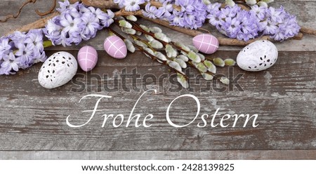 Decoration with flowers, Easter eggs and the inscription Happy Easter. German inscription translates as Happy Easter.