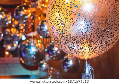 Decoration interior elements of restaurant venue banquet hall with multicoloured different helium balloons, on a indoor corporate event or wedding reception or birthday party celebration