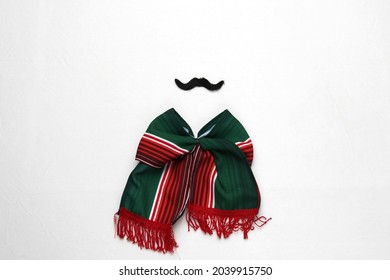 Decoration for Mexican party: tricolor tie bow, mustache, pinwheels, handmade doll with the colors of the Mexican flag green, white and red
