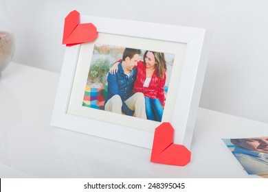 Decoration for Valentine's day. Frame with couple photo and origami hearts