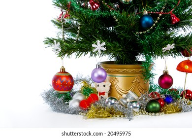 Decorations At The Base Of A Christmas Tree On A White Background