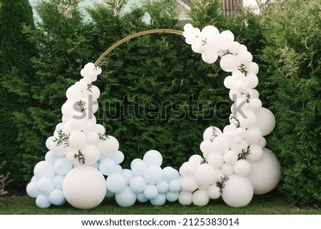 Decorations for holiday party. A lot of balloons blue and white colors. Round photo zone with balls