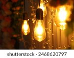 Decorative antique edison style light bulbs against yellow curtain background