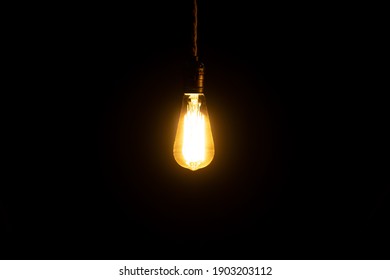 Decorative antique edison style light bulb glowing in the dark. Interior bulb. - Powered by Shutterstock