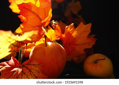 Decorative Apple And Leaves In Fall Season, Vivid Orange Yellow Colors And Black Background