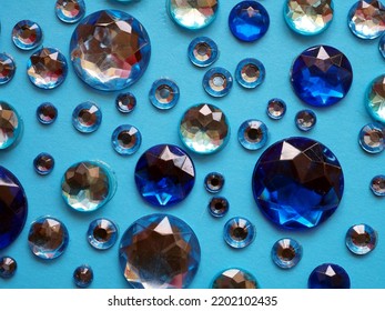 Decorative Backdrop For Design: Multifaceted Blue Sparkling Crystals On A Light Blue Background.