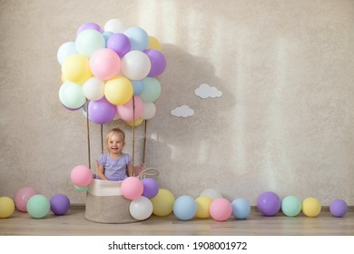 Decorative balloon basket, birthday, party. A little girl dreams of flying in a hot air balloon. Emotions are joy, fun. The natural light, the sun's rays. - Powered by Shutterstock