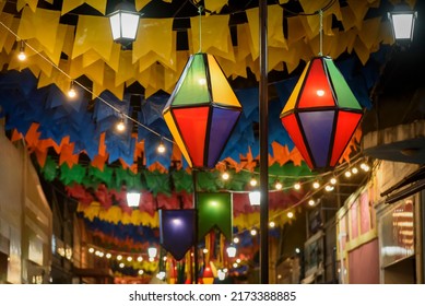 Decorative balloons and colorful flags on the street for the São João festival, which takes place in June in northeastern Brazil. - Shutterstock ID 2173388885