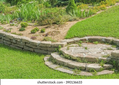 Decorative Blooming Alpine Slide On A Green Slope In The Garden On A Summer Day