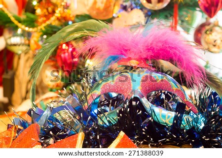 Decorative blue Christmas mask with holiday decorations background.