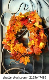 Decorative Bright Autumn Wreath Hanging On House Door Close Up. Beautiful Festive Decoration For Thanksgiving Or Halloween Party. Fall Season Background