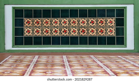 Decorative ceramic peranakan tile mosaic on the shop frontage of a traditional chinese shophouse.