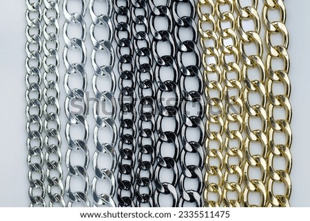 Decorative chains for bag handles and designer decoration of products. Metal chains in black, gold and silver colors to decorate garments.