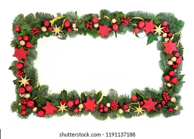 Decorative Christmas background border with red and gold star and ball bauble decorations with winter flora of holly, ivy, mistletoe and spruce fir. Festive theme.
