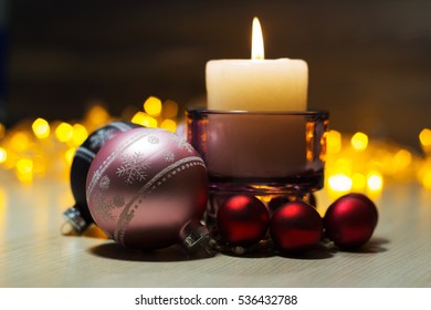 Decorative Christmas composition with a candle and Christmas toys
