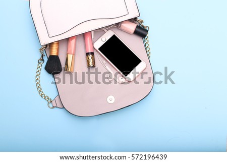 Decorative cosmetics and accessories for makeup on blue background