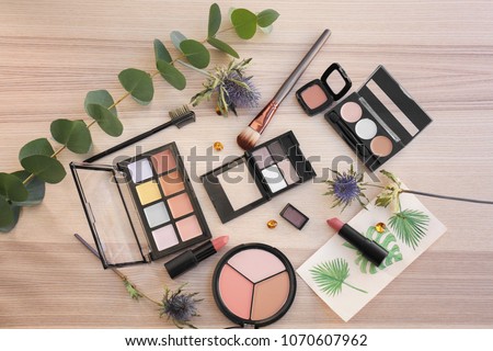Decorative cosmetics on light wooden background