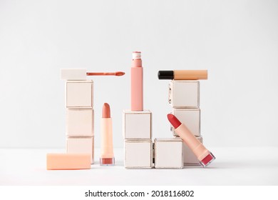 Decorative cosmetics and wooden cubes on white background - Shutterstock ID 2018116802