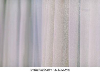 Decorative curtains are made in light warm colors. - Shutterstock ID 2141420975