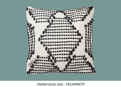 Decorative cushion with knitted pattern. Isolated on green background.