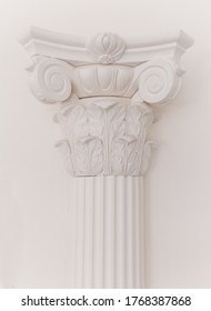 Decorative detail of an ancient white Ionic column. close up.