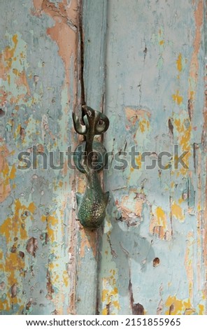 Decorative door knocker on a wooden door from Malta, door knob Dophin. Malta, traditional door,  knocker