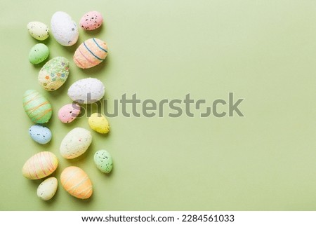 decorative easter eggs on colored background. easter eggs collection top view with copy space.