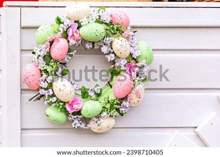 Decorative Easter wreath with bright eggs. Handmade Easter wreath