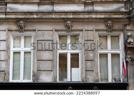 Decorative elements in the form of a head, mascarons over the windows in the building on Cybulskiego street in Wroclaw