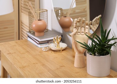 Decorative elements on wooden dressing table in room