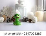 Decorative figurine made of ceramic in the form of a snake. Christmas tree decoration. Holiday decor, home decoration. Christmas theme