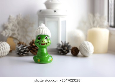 Decorative figurine made of ceramic in the form of a snake. Christmas tree decoration. Holiday decor, home decoration. Christmas theme - Powered by Shutterstock