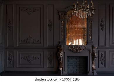 Decorative fireplace, vintage mirror and chandelier in classical black room interior - Shutterstock ID 1740443186