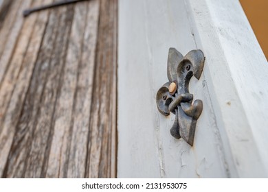 A decorative fleur de lis shaped doorbell in the French Quarter in New Orleans.