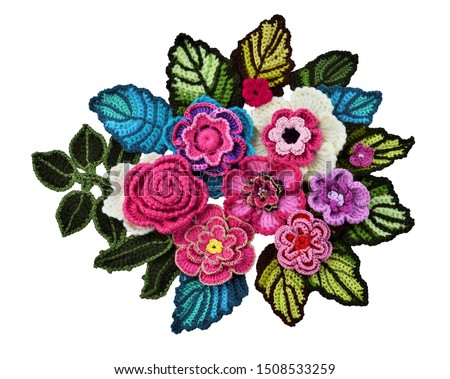 Decorative floral applique in boho style from freeform crocheted flowers and leaves isolated on white background.