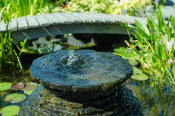 Decorative Fountain In Fish Pond