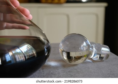 Decorative Glass Cork And Carafe Of Red Wine In The Kitchen Interior. Hand On The Decanter. Selective Focus.