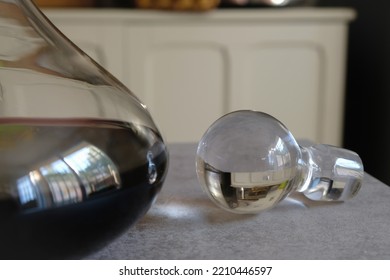 Decorative Glass Cork And Carafe Of Red Wine. The Kitchen Interior Reflects In The Glass. Selective Focus.