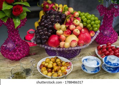 Decorative Glass Porcelain Basket With Ripe Fresh Grapes, Apples And Dragonfruit On A Table In A Chinese Tea Shop