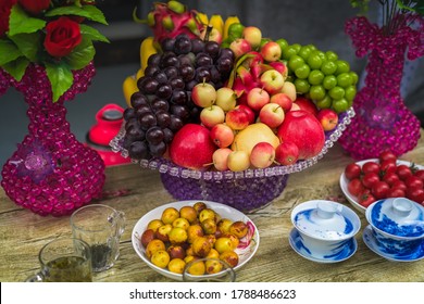 Decorative Glass Porcelain Basket With Ripe Fresh Grapes, Apples And Dragonfruit On A Table In A Chinese Tea Shop