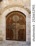 Decorative,  gold embossed and wood door with the name of the synagogue in Hebrew, which translates to the "Eliyahu HaNavi Synagogue," located in the Jewish Quarter of the Old City of Jerusalem. 