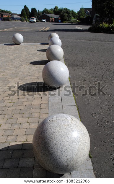 Decorative Granite Balls on Concrete Pavement beside Car\
Park 