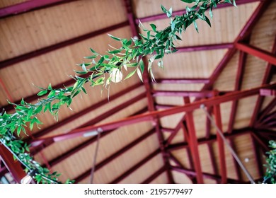 Decorative Green Garlands Made Of Plants. Wedding Decorations, Boho Style. Rustic Decor. Garlands From Plants With Lighting From Garden Lights. Greenery. 