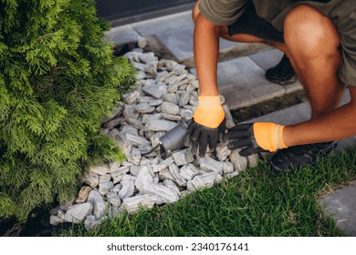 Decorative ground in the garden with artificial grass, gravel and explsed aggregate finish. - Shutterstock ID 2340176141