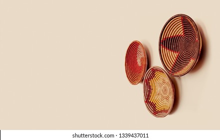 Decorative Handwoven Rwandan Grass Baskets Hanging On A Wall. Beautiful And Colourful East African Home Decor Items. Handmade Ethnic Arts And Crafts Backdrop With Copy Space.