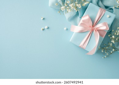Decorative image featuring a delicate gift box adorned with pink ribbon and surrounded by flowers, set on a light blue backdrop to convey celebration, love, and thoughtful appreciation