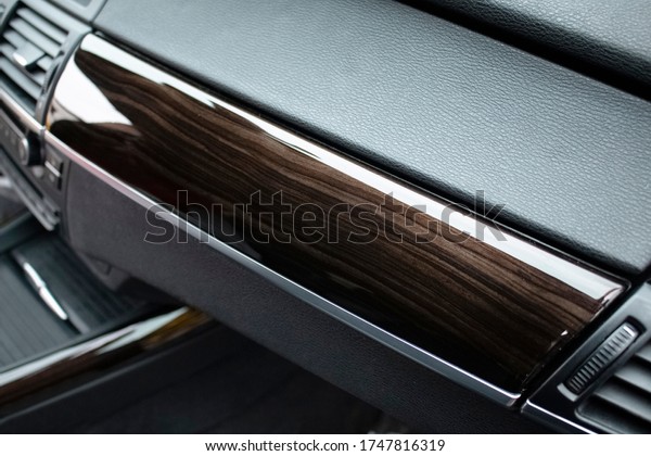 Decorative insert on the car panel painted under the\
brown wood