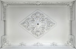 Decorative Item Made Of White Plaster On Ceiling. Relief Stucco Interior