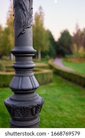 Decorative Lamp Post Column In A Park. Ornamental Black Metal Close Up.