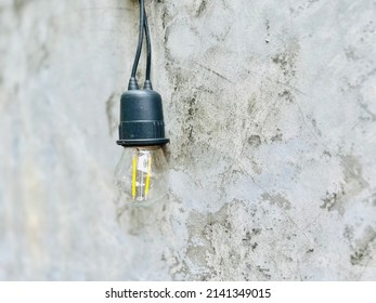 Decorative Light Bulb String On Concrete Wall